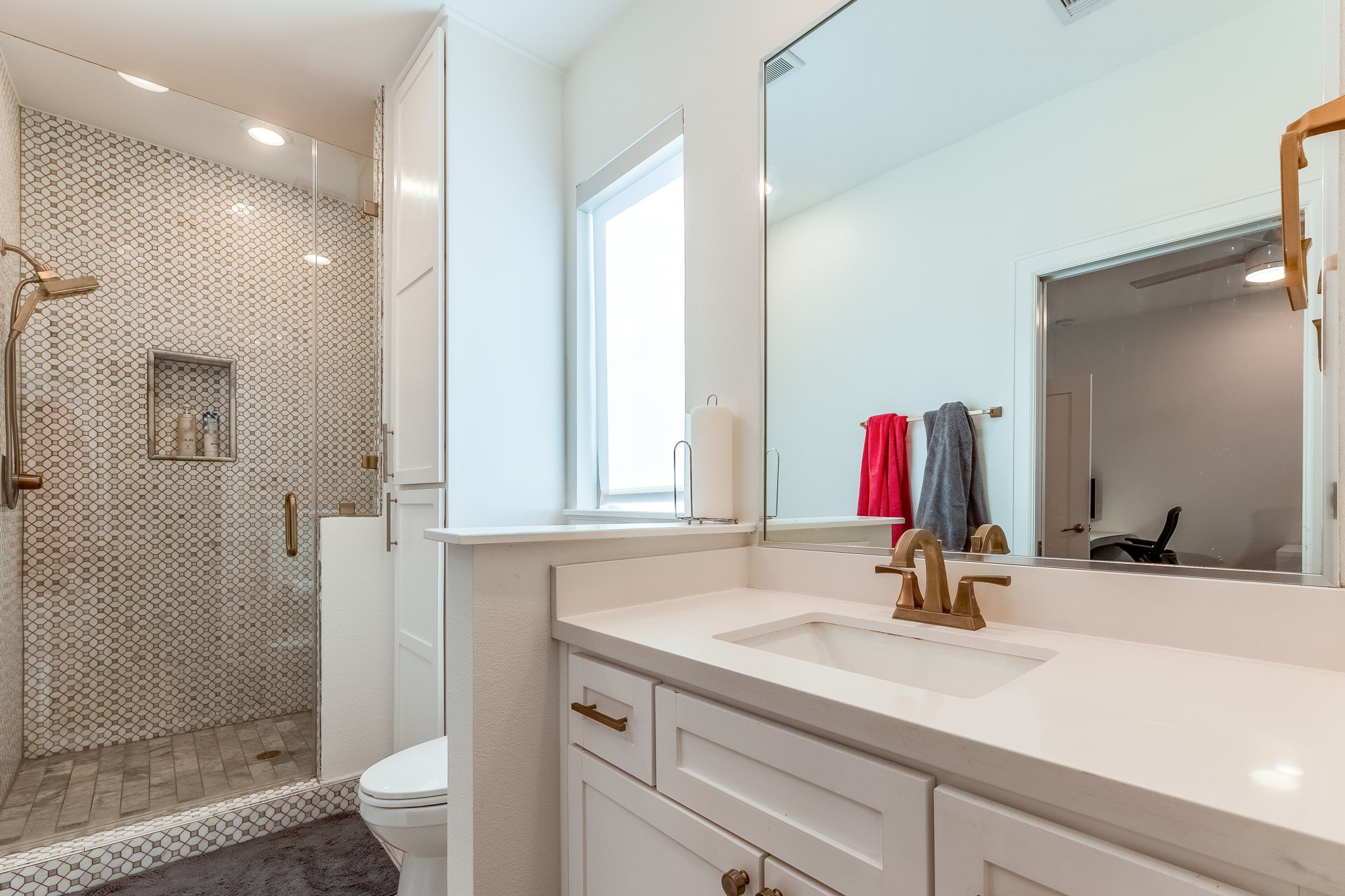 2124 Banks Street Houston, TX 77098 - Photo 22 of 46 a bathroom with a sink and a mirror