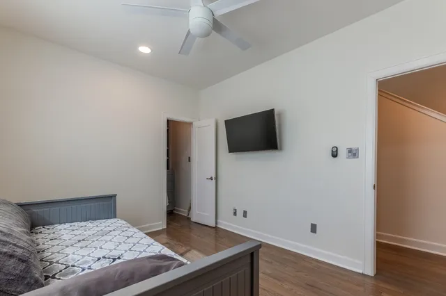 a bedroom with a bed and a flat screen tv