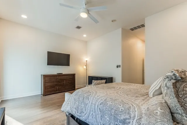 a bedroom with a bed and a flat screen tv