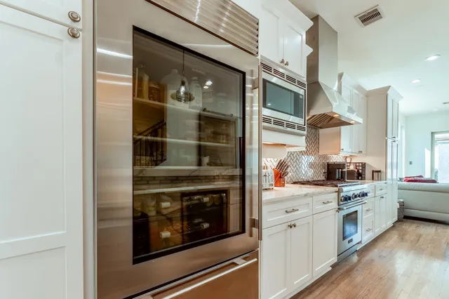 a kitchen with stainless steel appliances granite countertop a stove and a refrigerator