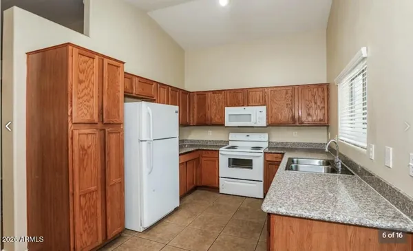 a kitchen with a stove a sink and a refrigerator