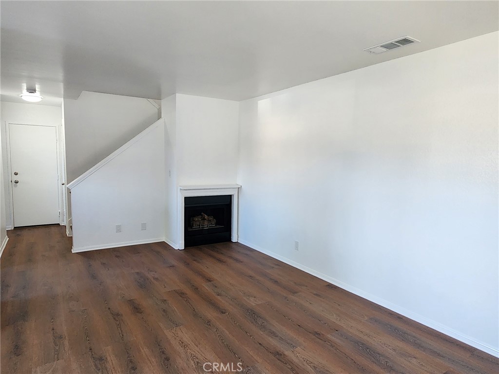 520 Claraday Street, Unit 1 Glendora, CA 91740 - Photo 4 of 16 a view of an empty room with wooden floor and a window