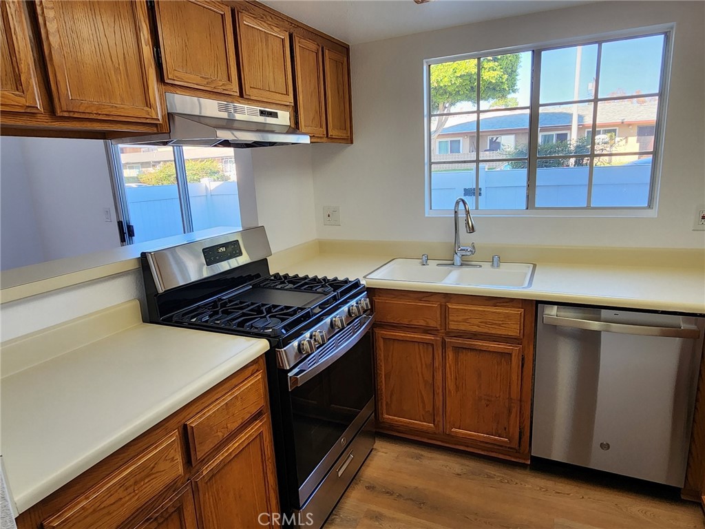 520 Claraday Street, Unit 1 Glendora, CA 91740 - Photo 5 of 16 a kitchen with stainless steel appliances granite countertop a sink stove and cabinets