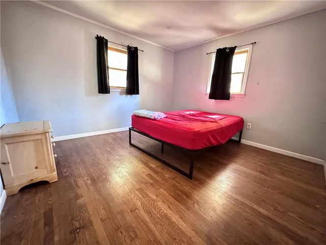 a spacious bedroom with a bed and window