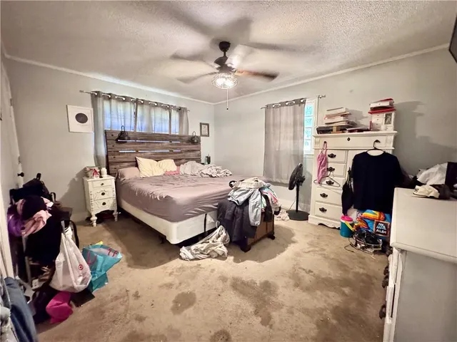 a bedroom with a bed and a tv