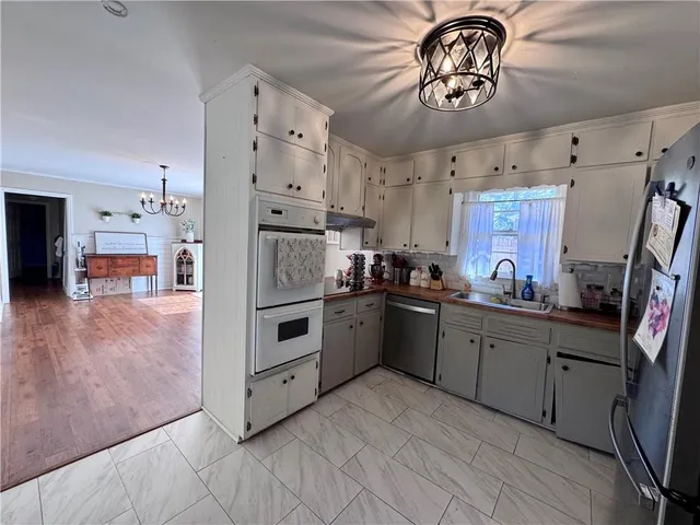 a kitchen with cabinets and wooden floor