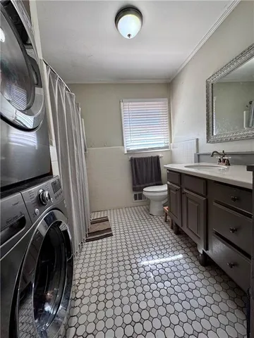 a bathroom with a sink toilet and mirror