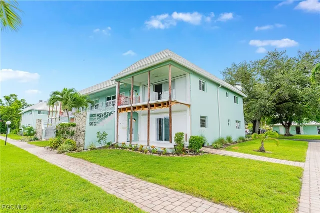 a front view of house with yard and green space