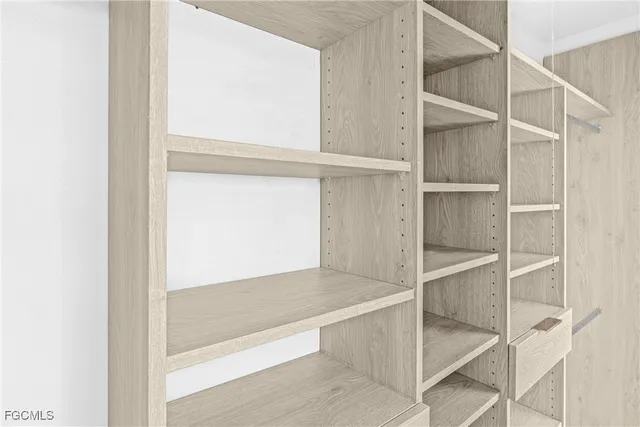 a view of walk in closet with empty racks