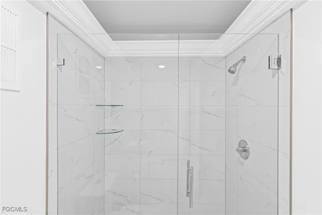 a bathroom with a glass shower door