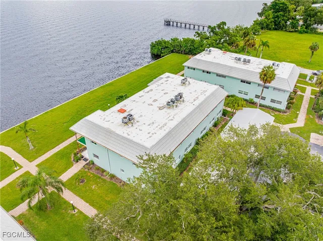an aerial view of a house with a garden and swimming pool