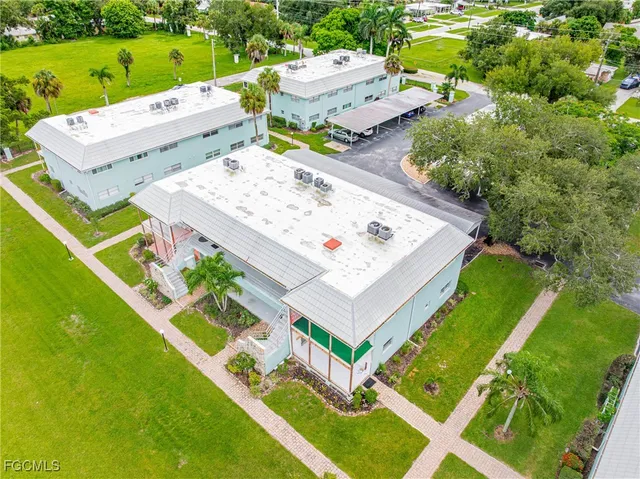 an aerial view of a house with a garden and swimming pool