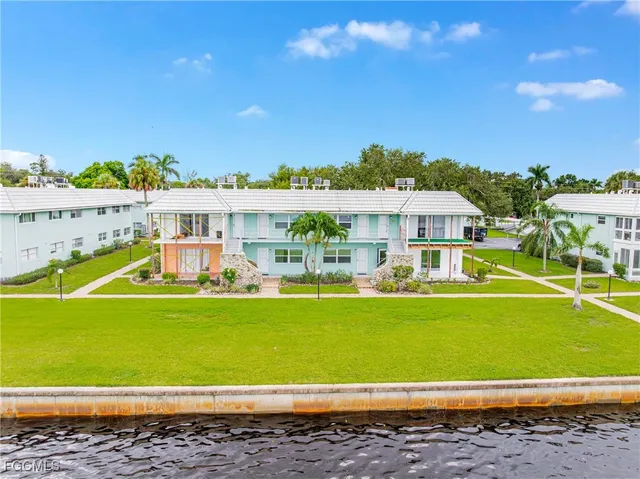 a view of a big house with a big yard