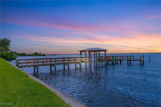 a view of a swimming pool with outdoor seating and plants