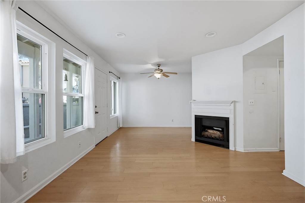 8167 Vineyard Avenue, Unit 47 Rancho Cucamonga, CA 91730 - Photo 13 of 22 an empty room with windows and fireplace