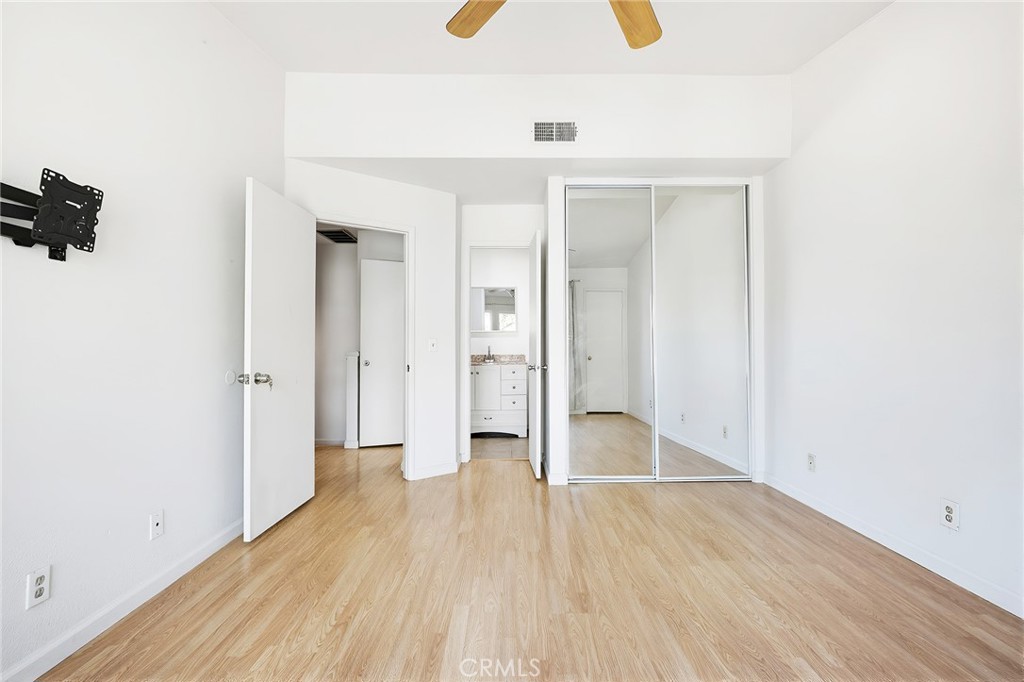 8167 Vineyard Avenue, Unit 47 Rancho Cucamonga, CA 91730 - Photo 21 of 22 a view of a hallway with wooden floor