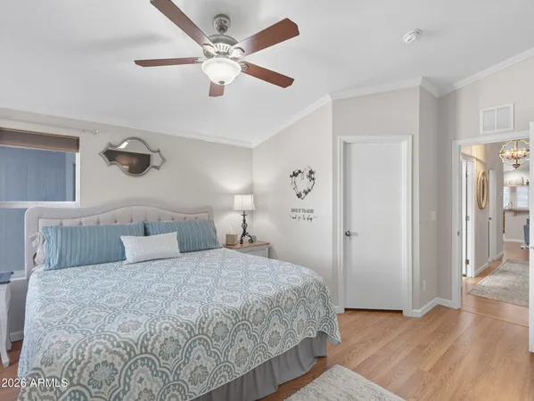 a bedroom with a large bed and a mirror on dresser