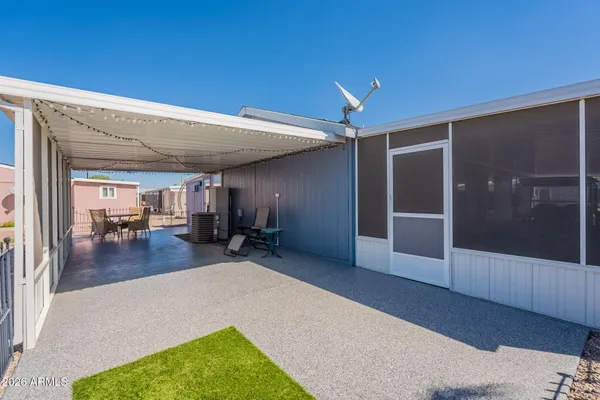 a view of a chairs and table in the balcony