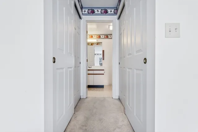 a view of a hallway with wooden shelves