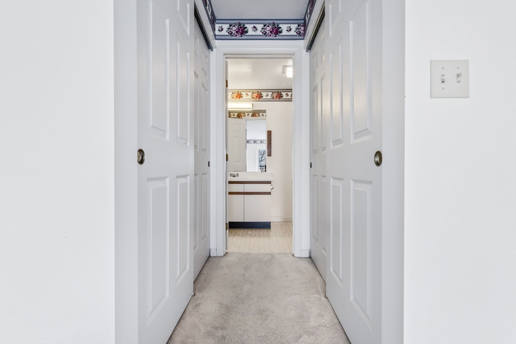 148 Main Street, Unit C538 North Andover, MA 01845 - Photo 16 of 23 a view of a hallway with wooden shelves