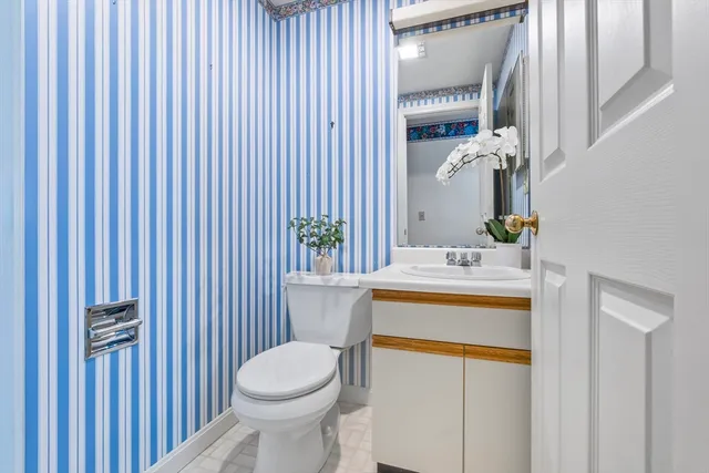 a view of a hallway with wooden floor and entryway