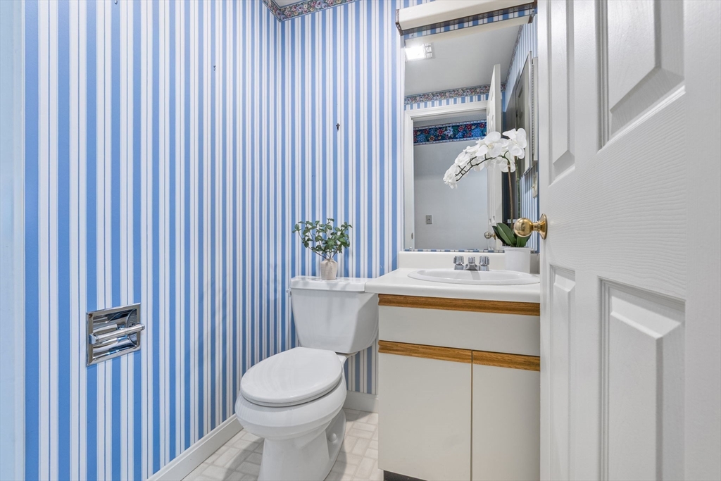 148 Main Street, Unit C538 North Andover, MA 01845 - Photo 21 of 23 a bathroom with a sink a toilet and mirror