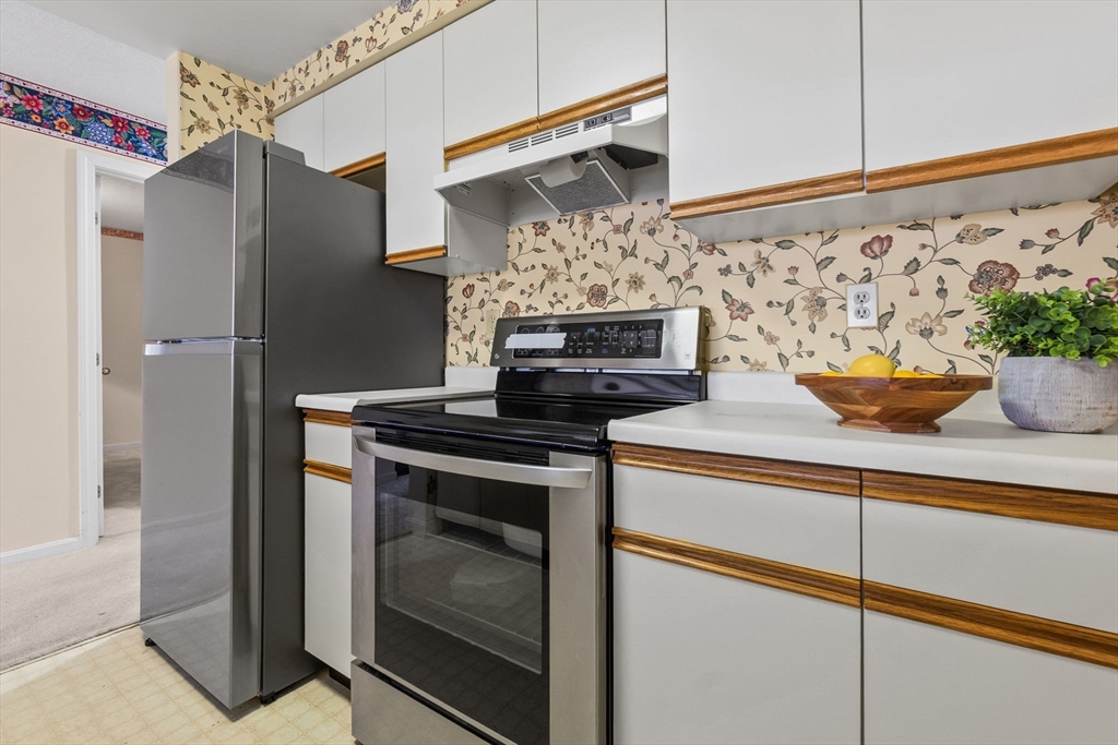 148 Main Street, Unit C538 North Andover, MA 01845 - Photo 6 of 23 a kitchen with stainless steel appliances granite countertop a refrigerator and a stove