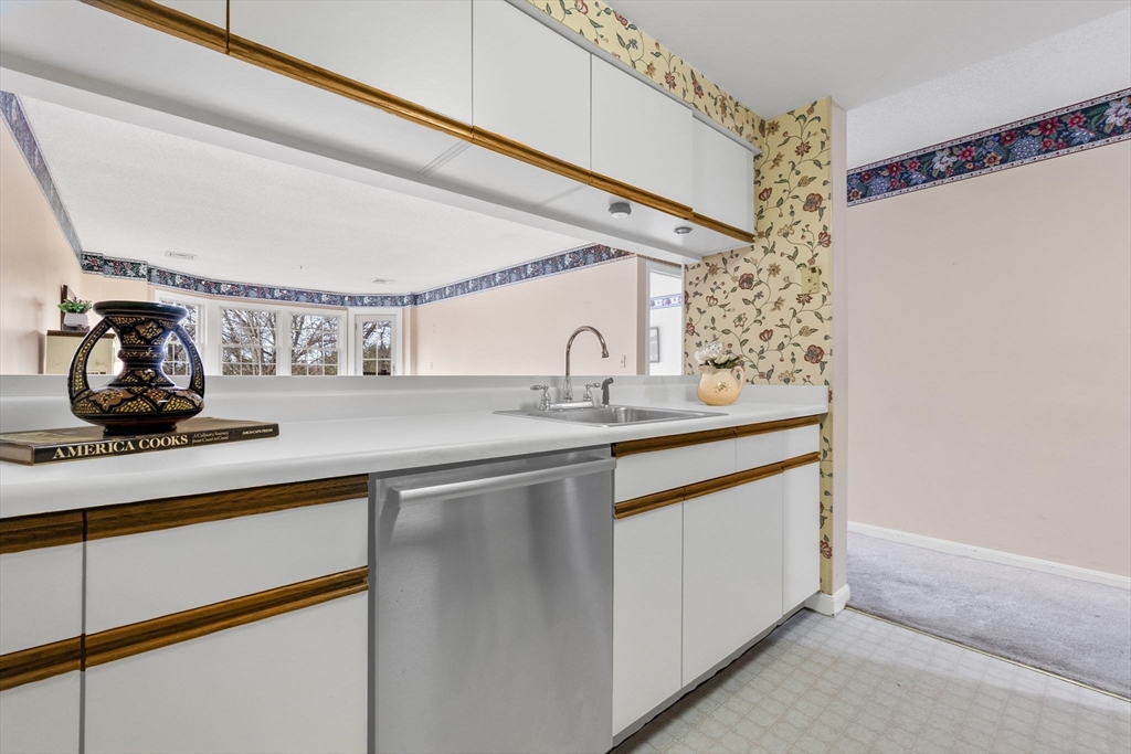148 Main Street, Unit C538 North Andover, MA 01845 - Photo 7 of 23 a kitchen with a sink and a mirror