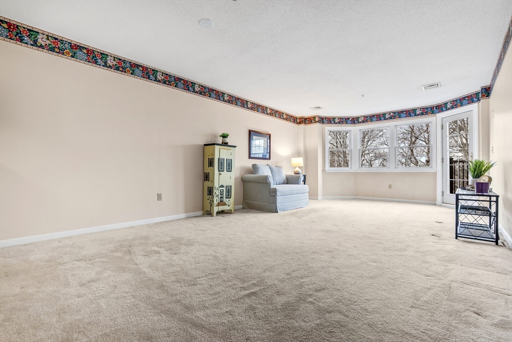 148 Main Street, Unit C538 North Andover, MA 01845 - Photo 8 of 23 a view of a livingroom with furniture and window