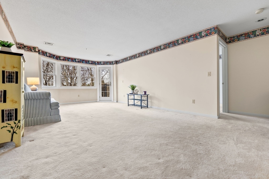 148 Main Street, Unit C538 North Andover, MA 01845 - Photo 10 of 23 a view of an empty room with a window