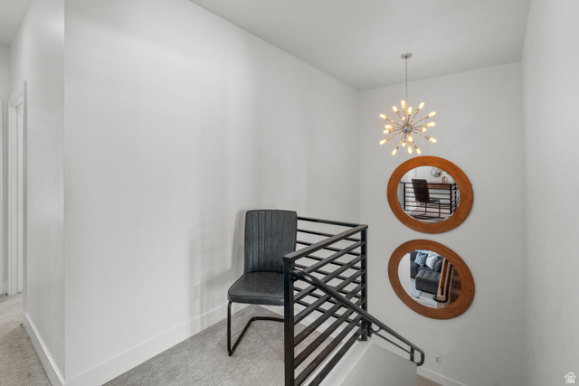 1122 South 1790th West, Unit 1 St. George, UT 84770 - Photo 18 of 37 Staircase featuring contemporary metal railings, plush carpeting, and a modern sputnik chandelier