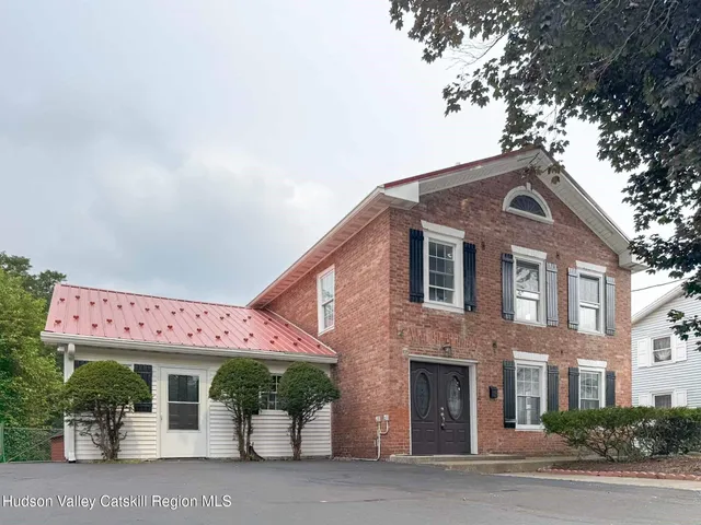 a front view of a building with garden