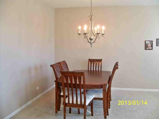 254 Cassidy Lane Elgin, IL 60124 - Photo 7 of 10 a view of a dining room with furniture wooden floor and chandelier