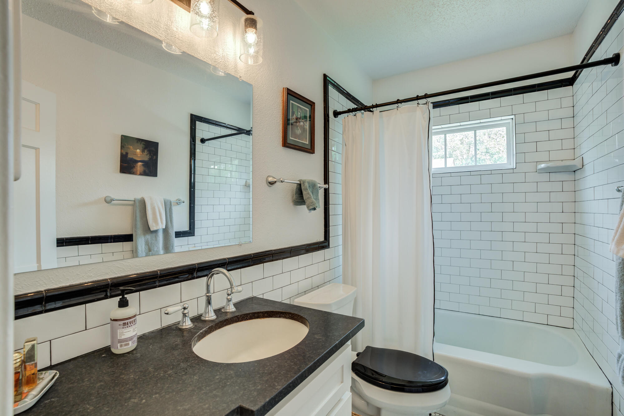 2826 33rd Street Lubbock, TX 79410 - Photo 16 of 33 a bathroom with a granite countertop sink and a mirror