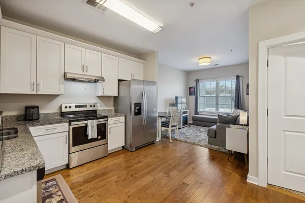 a kitchen with a refrigerator and a stove top oven