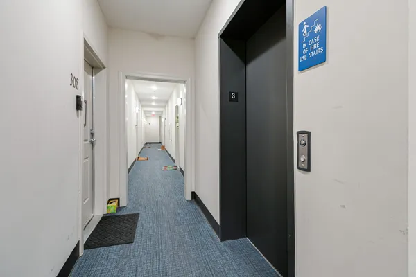 a view of a hallway with wooden floor