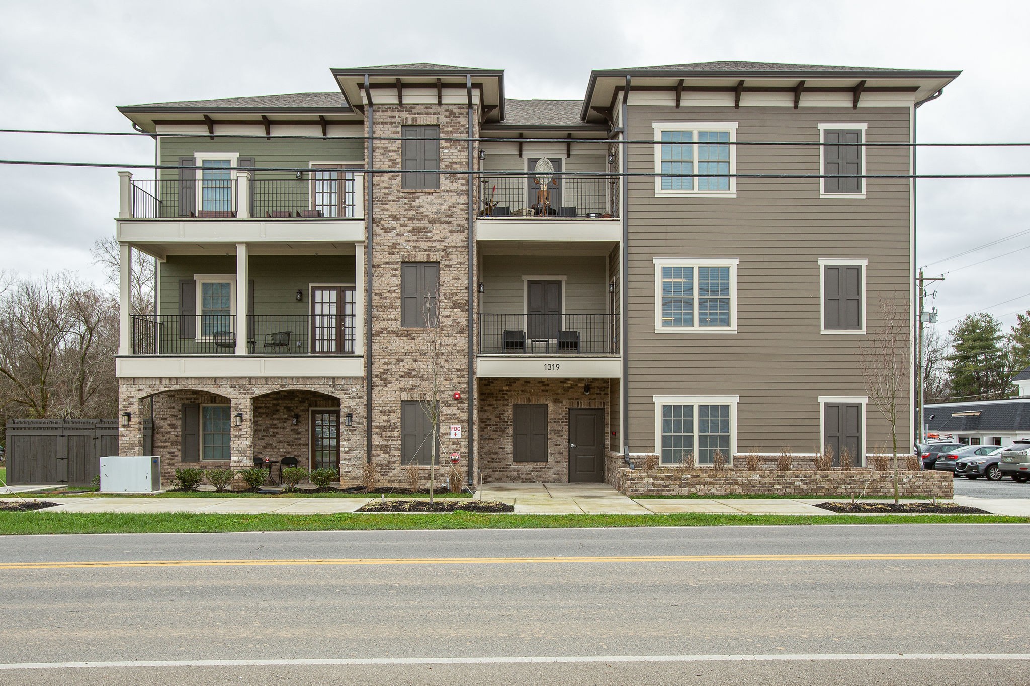 1319 West Main Street, Unit 303 Franklin, TN 37064 - Photo 2 of 23 a view of a brick house next to a yard