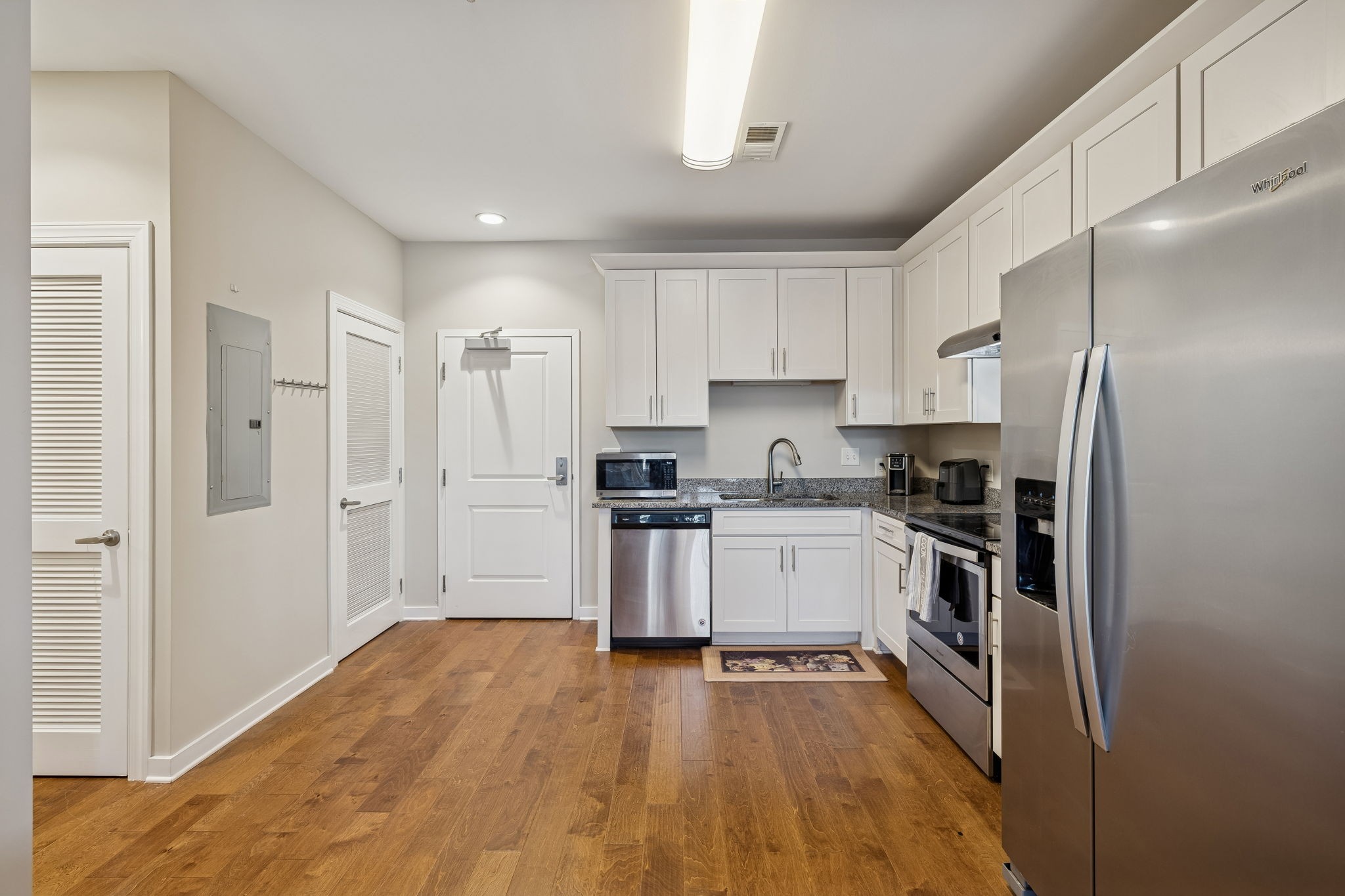 1319 West Main Street, Unit 303 Franklin, TN 37064 - Photo 8 of 23 a kitchen with a refrigerator a sink and a stove top oven