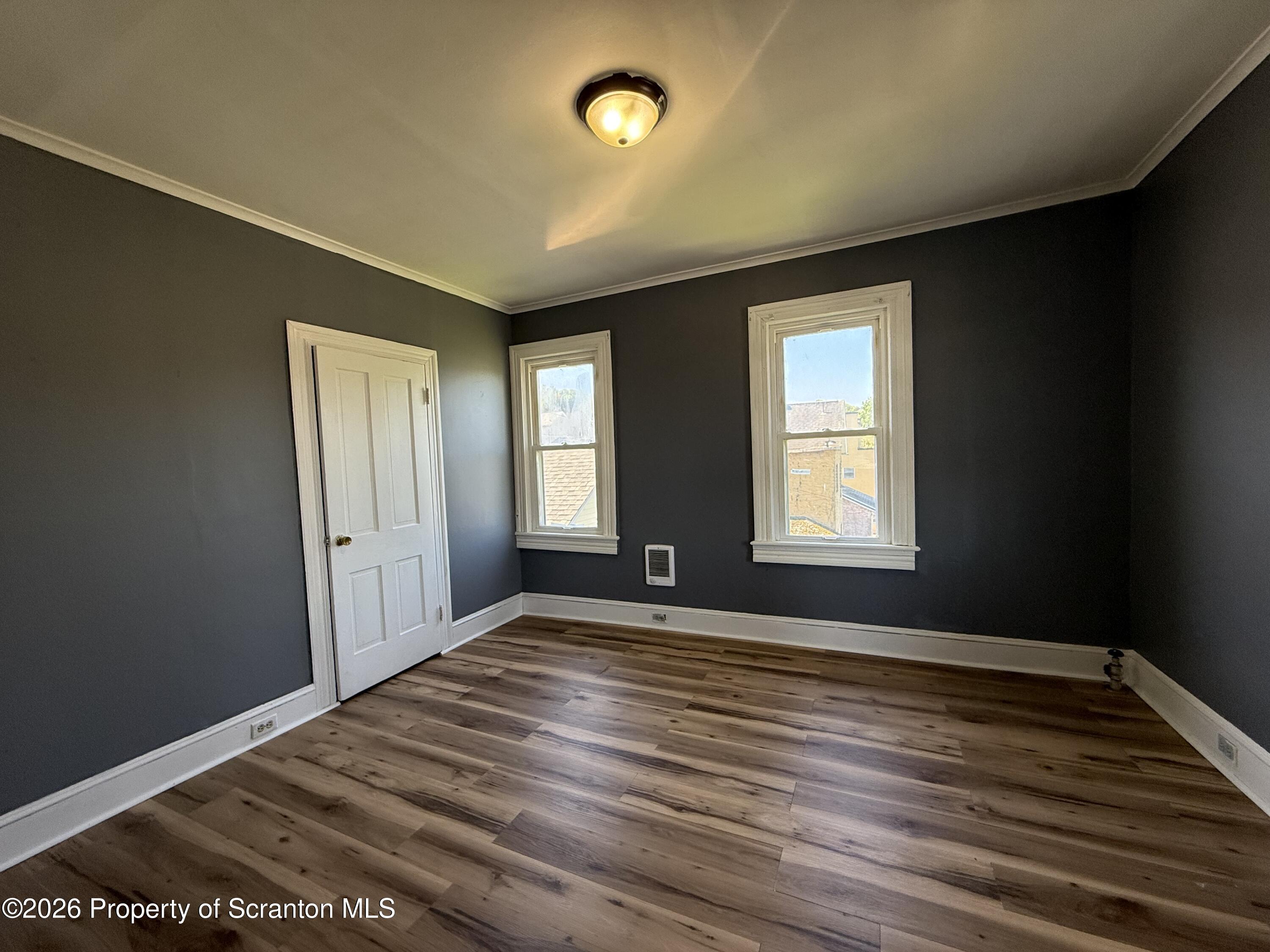 1706 Prospect Avenue, Unit 2 Scranton, PA 18505 - Photo 12 of 16 a view of an empty room with window and wooden floor