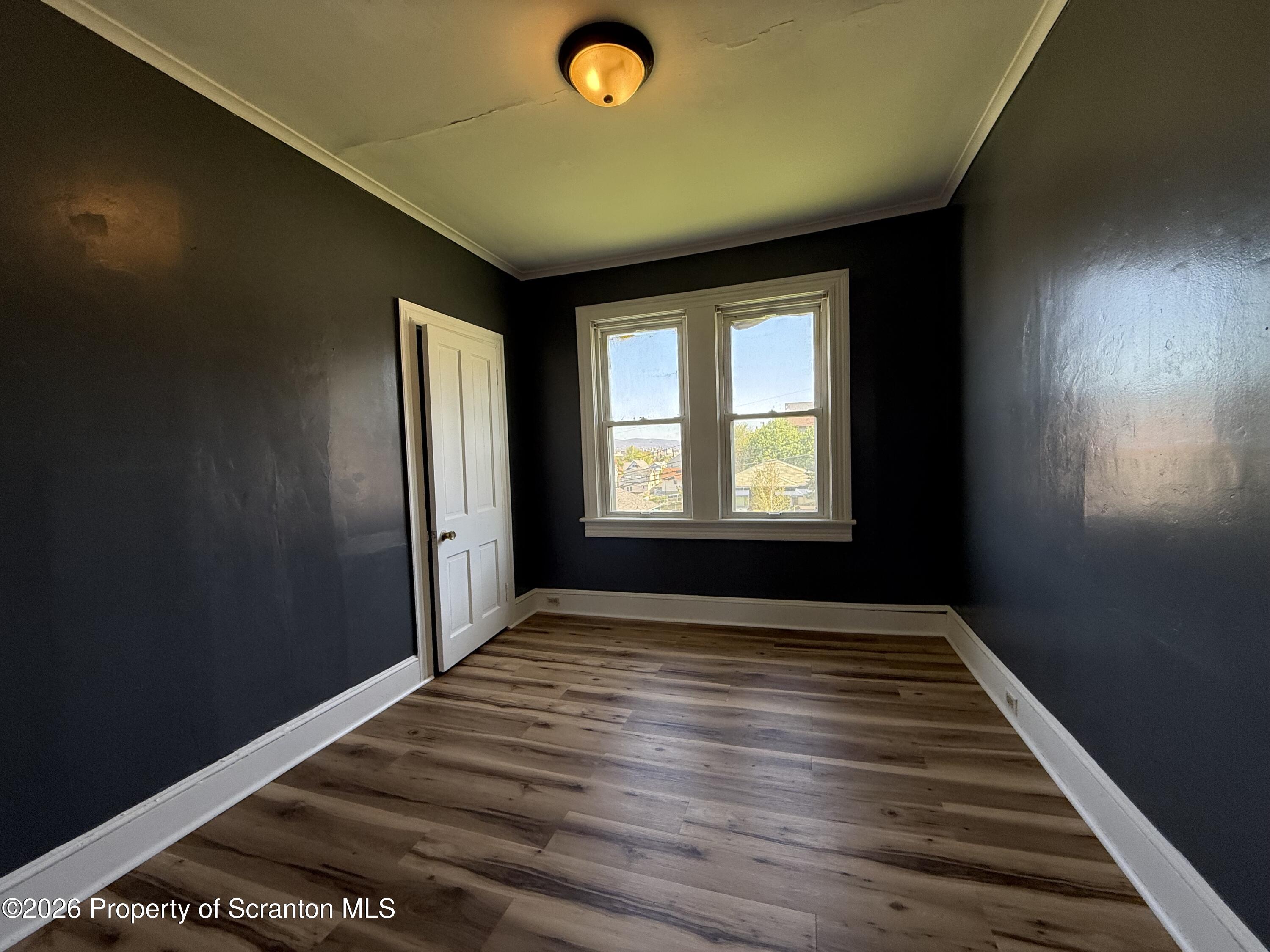 1706 Prospect Avenue, Unit 2 Scranton, PA 18505 - Photo 8 of 16 a view of an empty room with wooden floor and a window