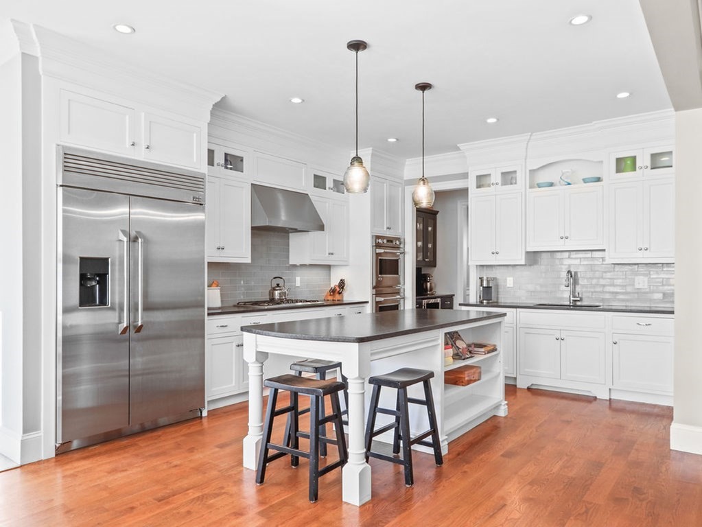 78 Mayflower Road Needham, MA 02492 - Photo 5 of 30 a kitchen with stainless steel appliances granite countertop a stove a sink a refrigerator and white cabinets with wooden floor