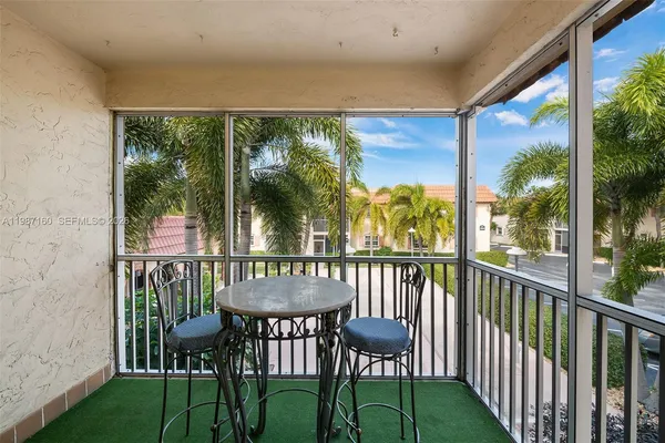 a view of a chairs and table in patio with a yard