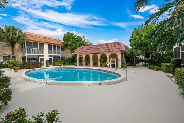 a view of house with swimming pool and outdoor seating