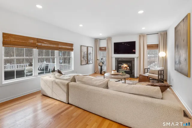 a living room with fireplace furniture and a flat screen tv