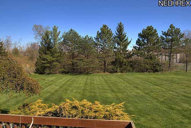 357 Longspur Road Highland Heights, OH 44143 - Photo 22 of 22 Large 18x12â?� deck leading to private, wooded, partially fenced yard with professional landscaping