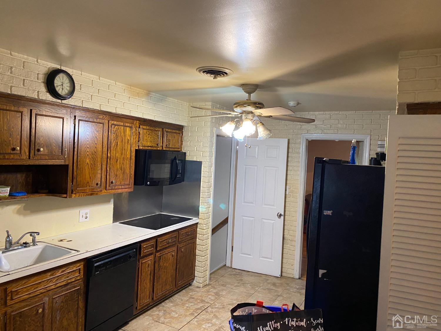 230 Austin Road Orange, NJ 07050 - Photo 14 of 34 a kitchen with stainless steel appliances granite countertop a sink refrigerator and cabinets