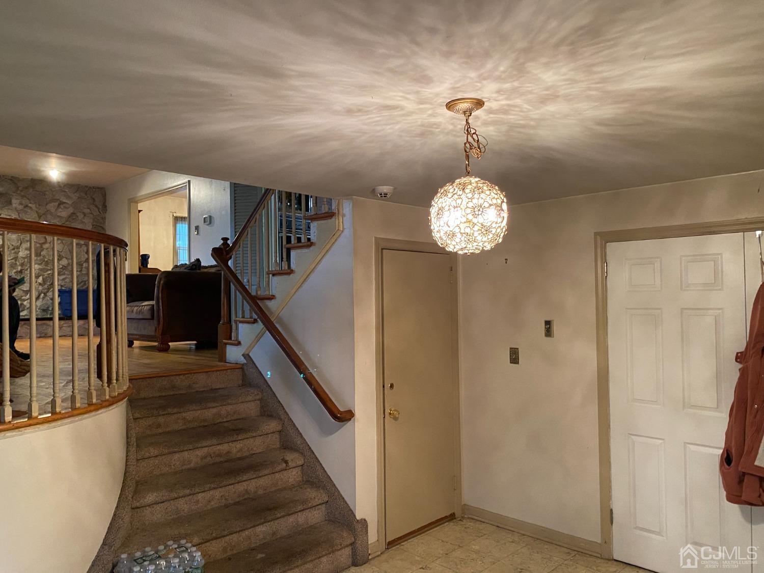 230 Austin Road Orange, NJ 07050 - Photo 9 of 34 a view of a hallway with wooden floor and staircase