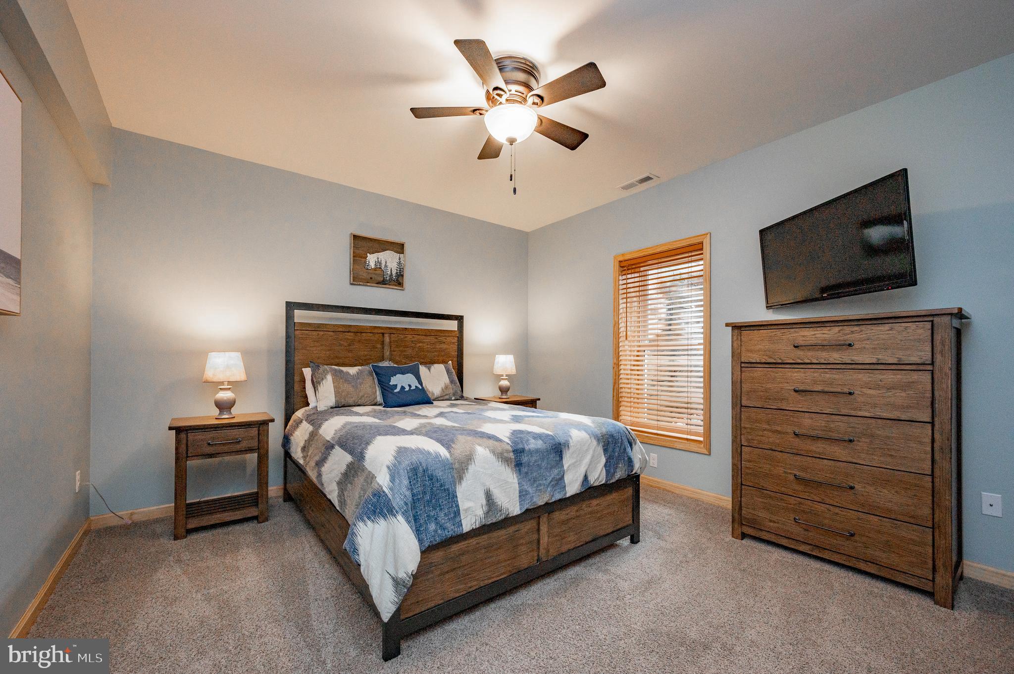 226 Wisp Adventure Road McHenry, MD 21541 - Photo 25 of 67 a bedroom with a bed and a flat screen tv