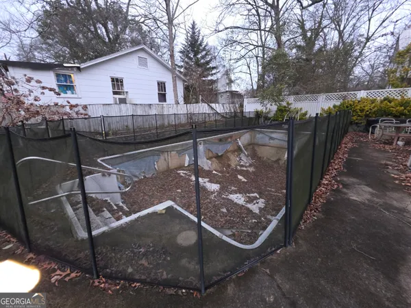 a view of a yard with plants and trees