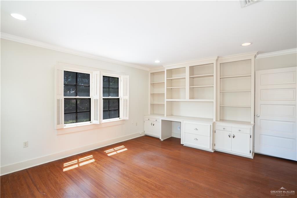 1131 West 6th Street Weslaco, TX 78596 - Photo 18 of 45 an empty room with cabinet and wooden floor